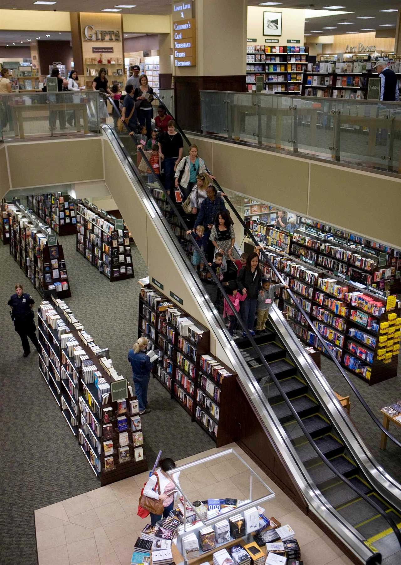 Customers take an escalator down to the first floor of a Barnes & Noble store