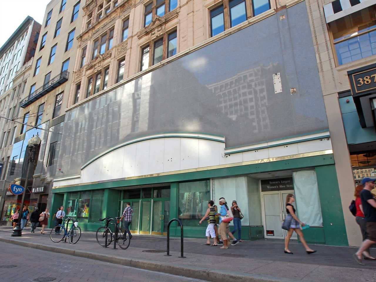 Pedestrians walk by a closed down Barnes & Noble in Boston