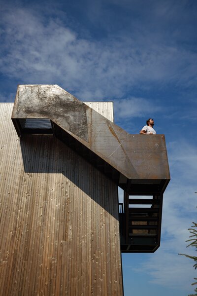 An exterior Cot-Ten staircase leads to the couple's rooftop patio, designed to "gain view planes above the single-story neighboring cottages,