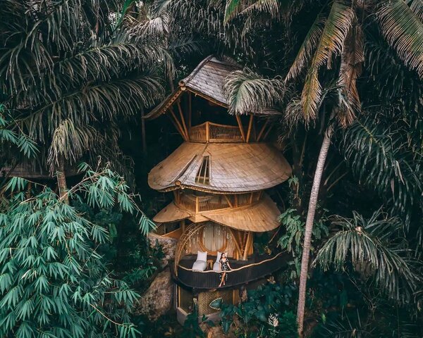 Secluded in a grove of giant black palms on the banks of the River Ayung in Abiansemal, Indonesia, near Ubud, Aura House is a unique ecological home crafted almost entirely from bamboo. The design is by renowned Balinese architecture studio Ibuku who wove the bamboo material to evoke the structure of a bird’s nest—perfect for a romantic getaway or an adventure in nature.