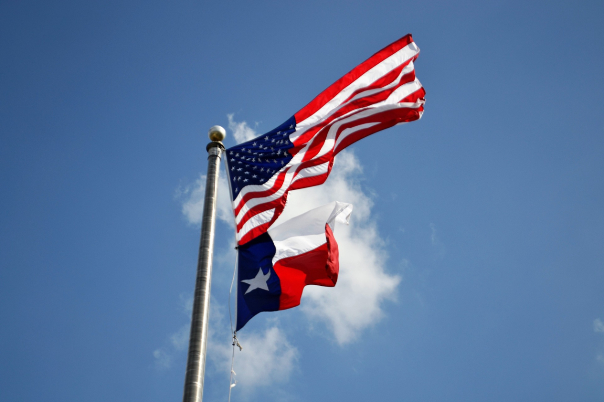 An American Flag above a Texas state flag