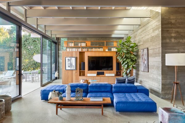 Inside, the main public spaces are delineated by board-formed concrete walls, built-in oak cabinetry, and radiant heated floors. The fully remodeled kitchen is located steps away.