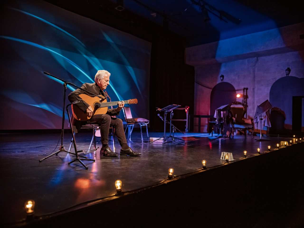 A guitarist on the stage with classic guitar