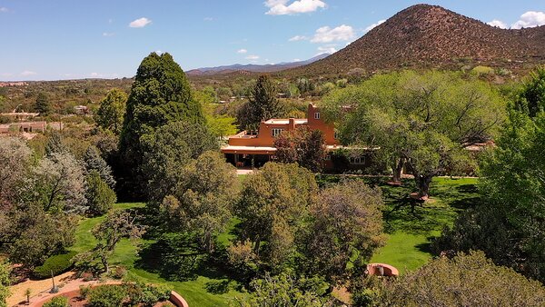 Located three miles outside of Santa Fe, the sprawling estate comes with thriving gardens, lush landscaping, and multiple shaded areas.