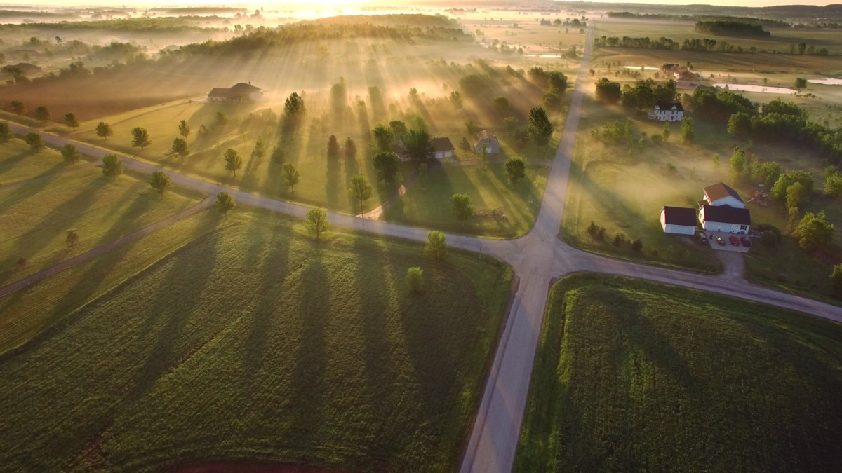 Magical sunrise through ground fog with long shadows and sunbeams