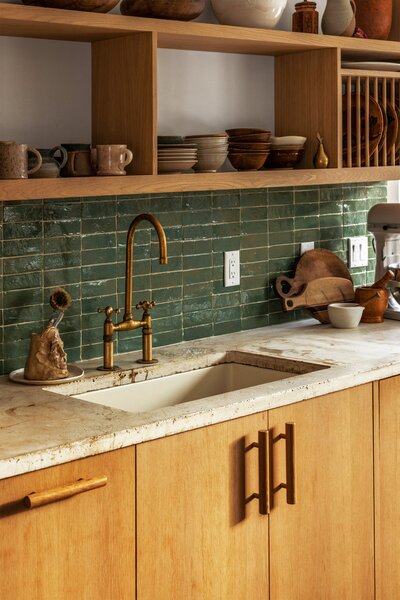 The kitchen has Landslide pendants from Twenty One Tonnes and a curved concrete island.