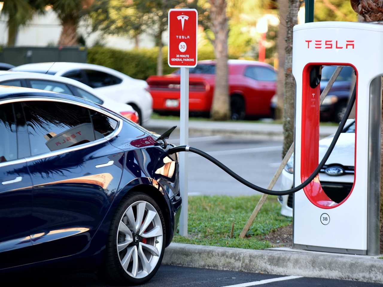 A Tesla Model 3 charges at a Supercharger.