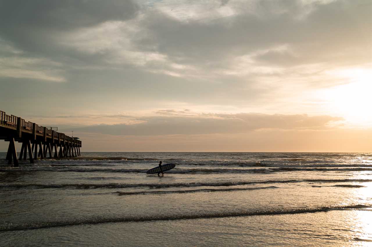 Atlantic coast with surfer outside in the sunset