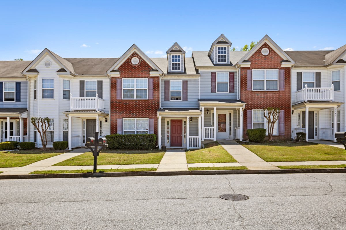 white and brown townhomes on a street