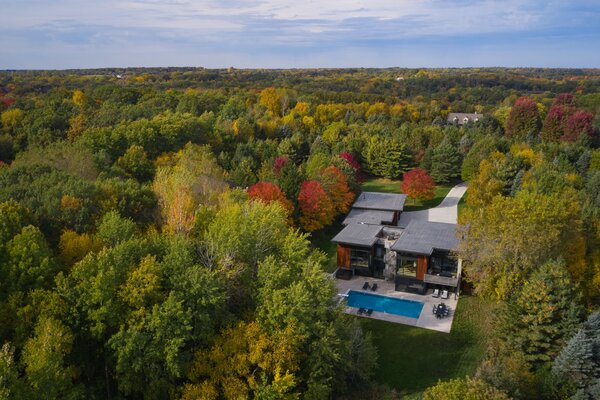 The renovation retained the existing footprint of the main living spaces, added a new primary bedroom suite, and relocated the garage.