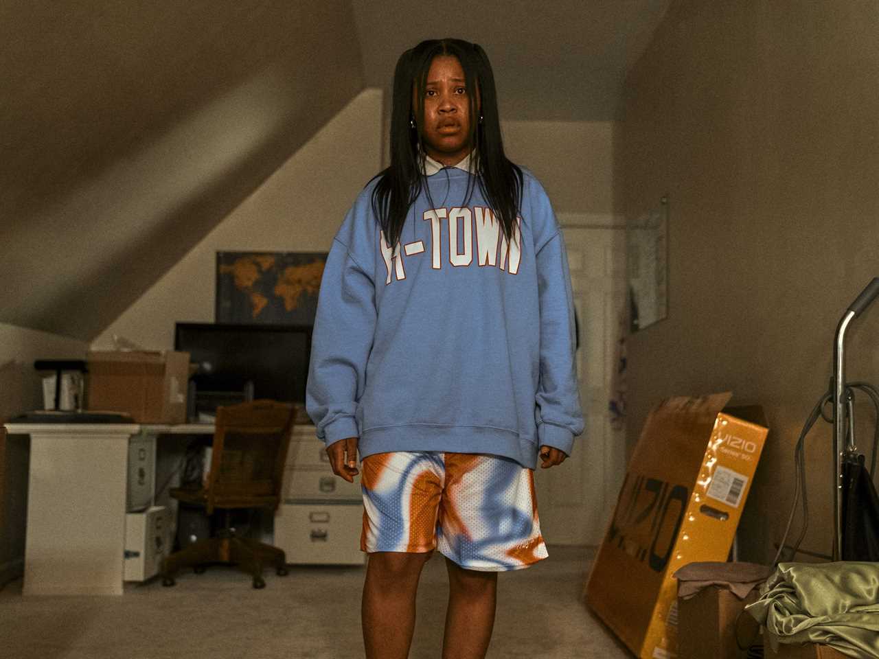 Dominique Fishback as Dre in "Swarm" looking concerned while standing in a room