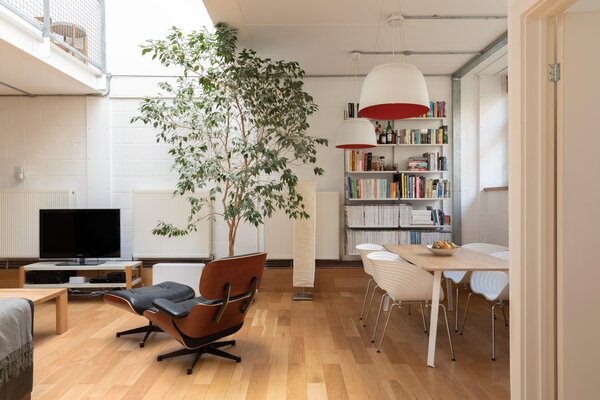 Inside, a wide entry opens up to the home's double-height kitchen, living, and dining areas.