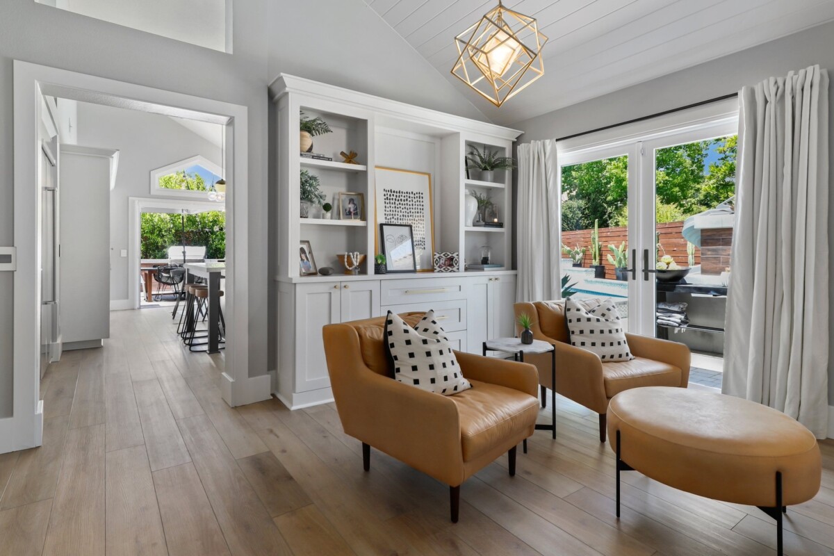 formal living room with bookcases and leather chairs