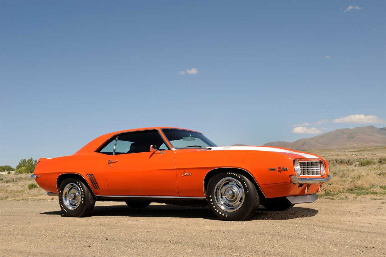 An orange 1969 Chevrolet Camaro in the desert.