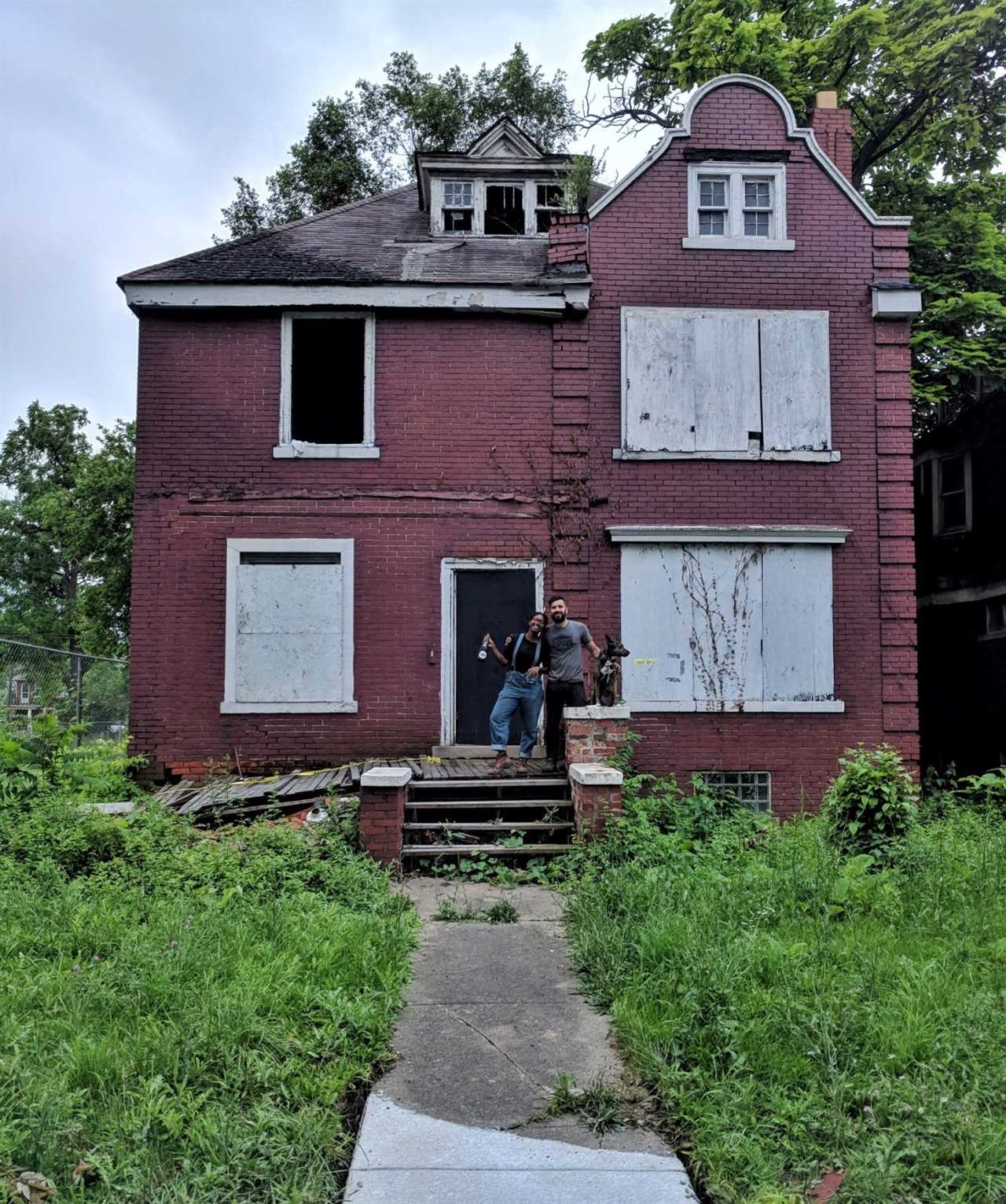 Kyle Dubay in front of a home he renovated.