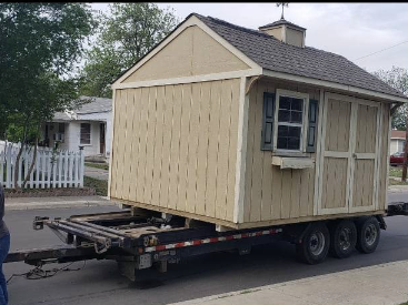 Yellow shed being transported