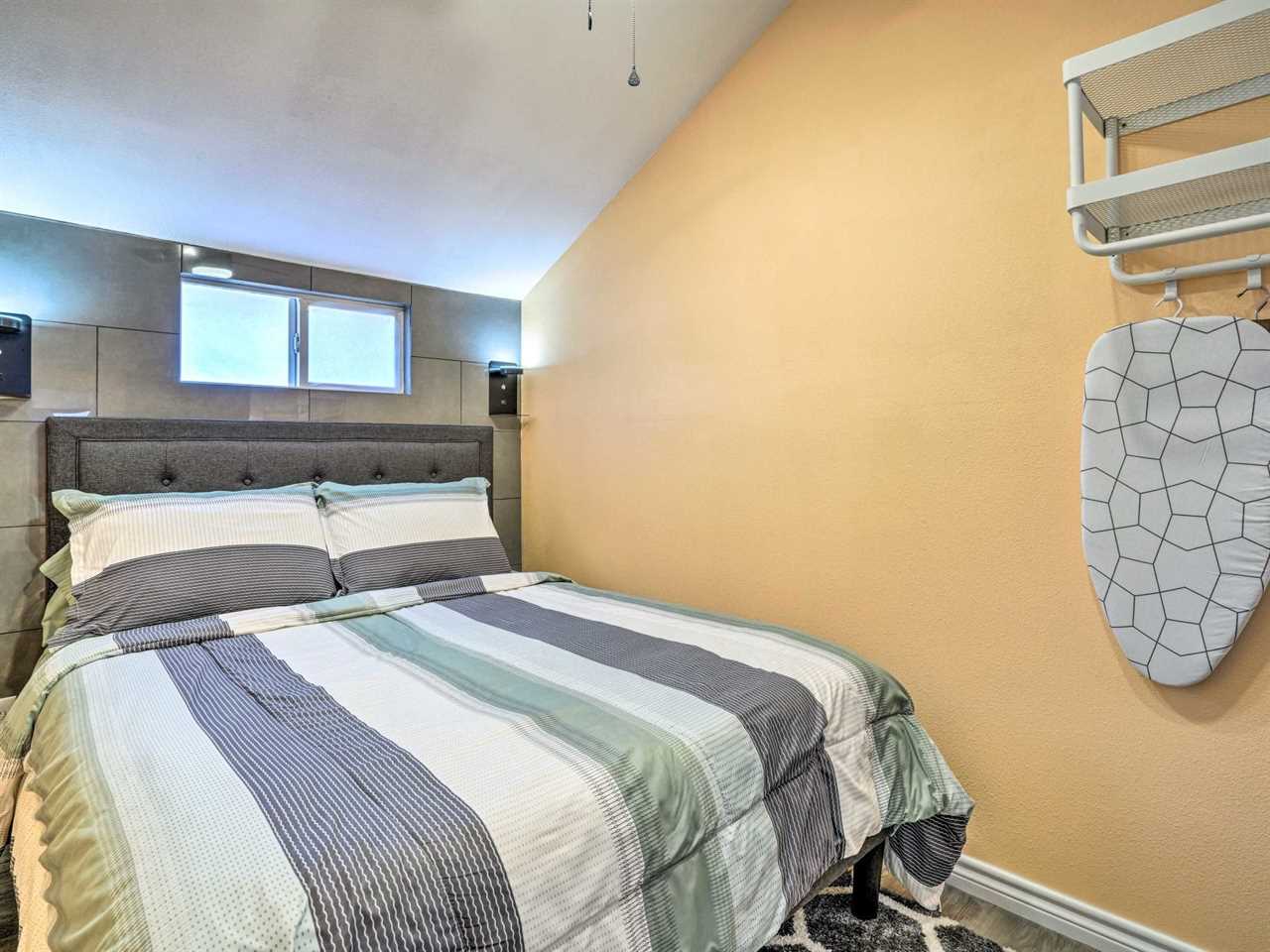 A yellow bedroom and blue and white bedspread