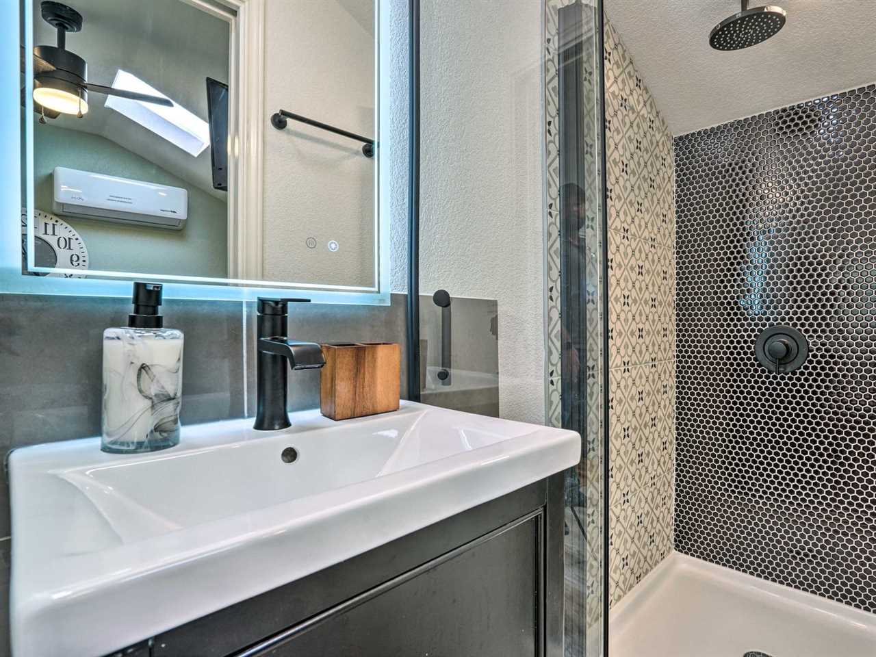 White sink bathroom and tile shower