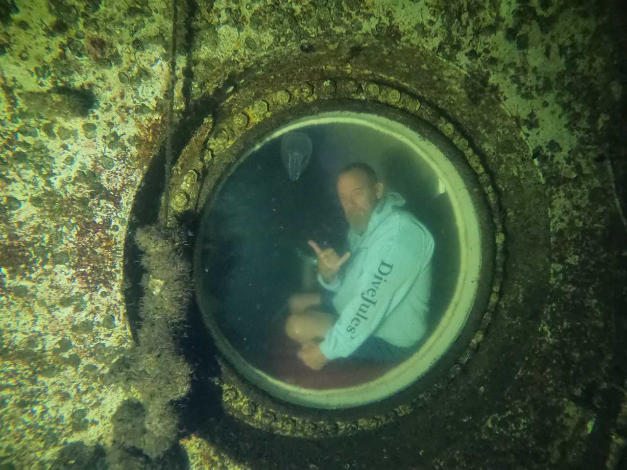 Thane Milhoan, habitat operations manager at Jules' Undersea Lodge, photographed from outside the habitat.