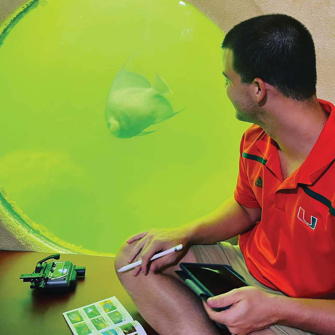 Scientist Harrison Albert observes an anglefish from inside Jules' Undersea Lodge.