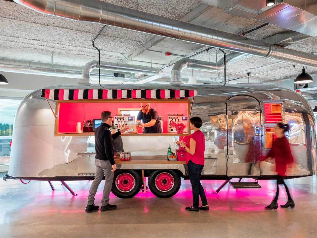 A vintage Airstream serving frozen yogurt in an office.