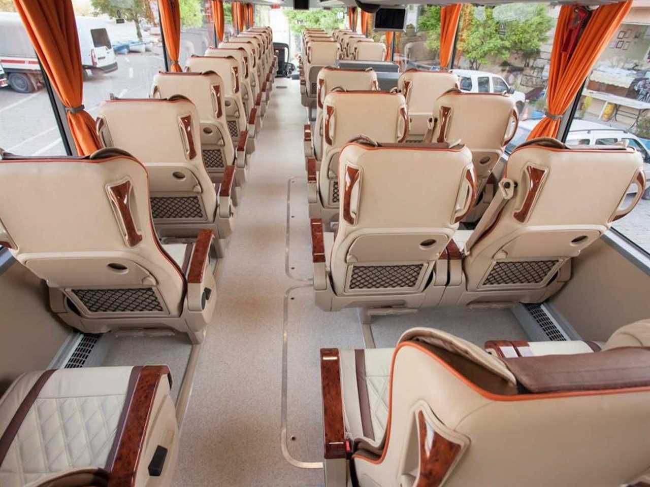 Inside the bus to London. The seats are beige and white.