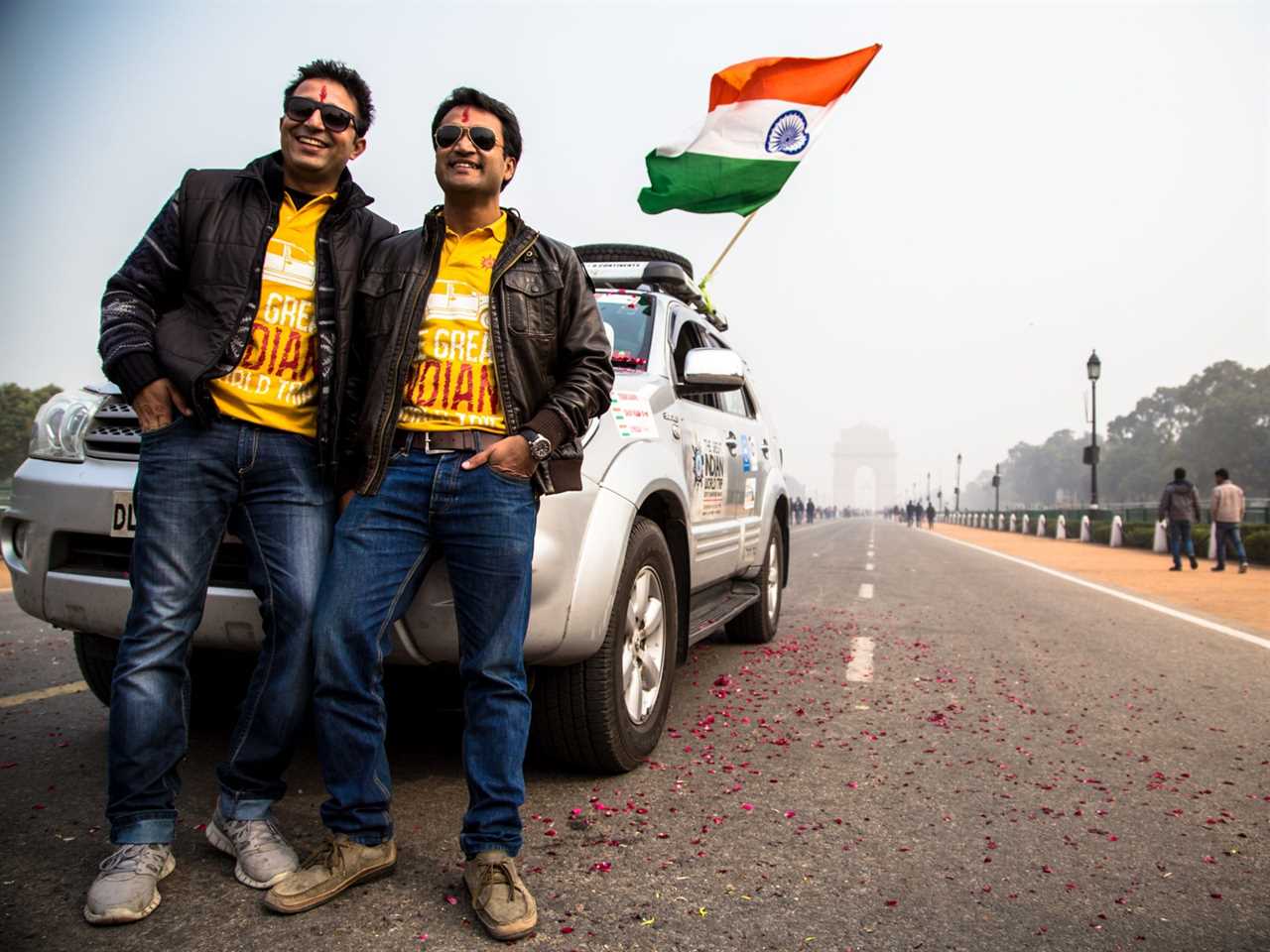 Two people standing on a road.