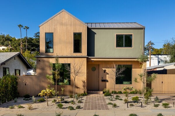 A tall fence borders the wood-clad home, offering a private oasis in the heart of Eagle Rock.