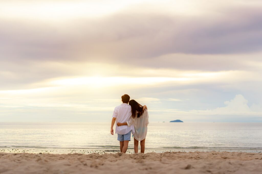 Couple ont he Beach watching the sun set