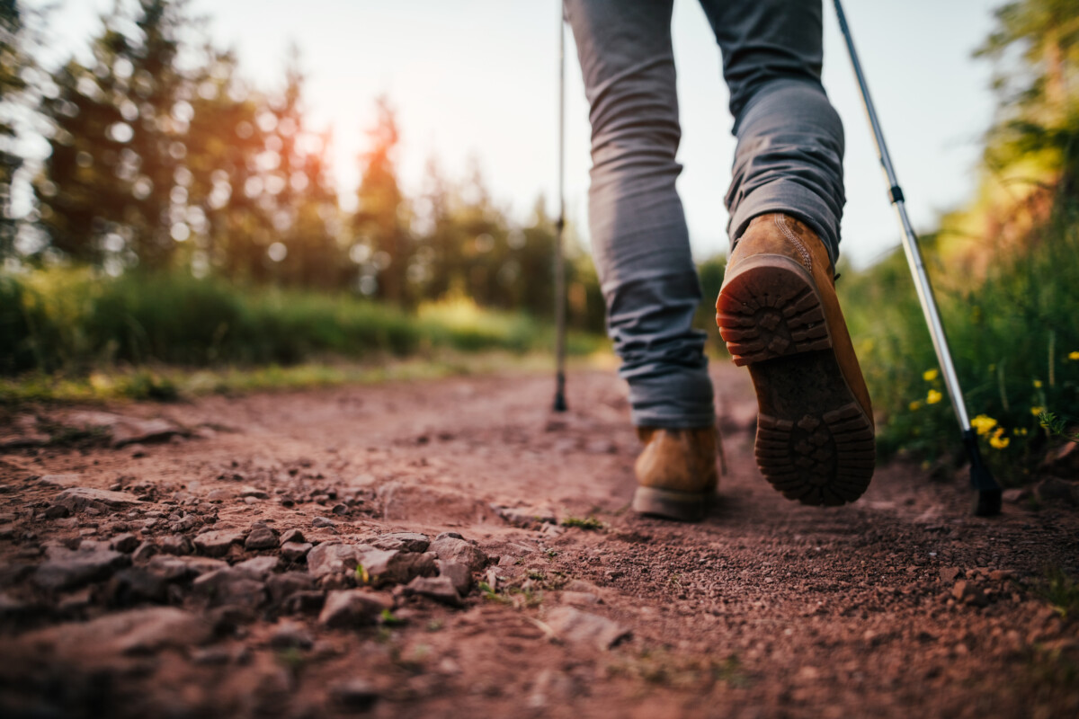 Hiker walks on Dirt Trail