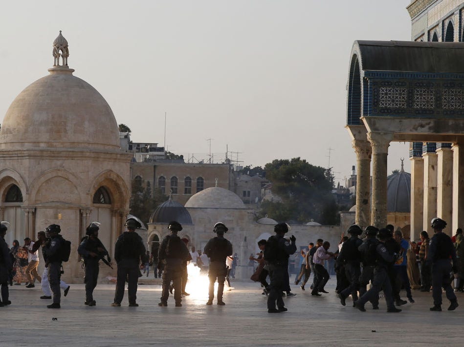 Israeli security forces fire tear-gas to disperse Palestinians after clashes broke out inside Al-Aqsa mosque's compound in Jerusalem's Old City on July 27, 2017.