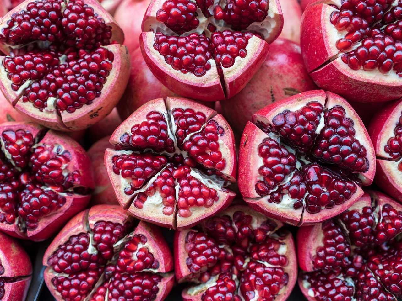 Many pomegranates cut into sections