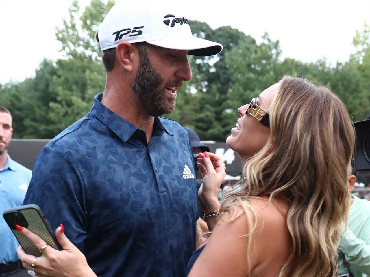 Team Captain Dustin Johnson of 4 Aces GC celebrates with wife, Paulina Gretzky, after winning the LIV Golf Invitational - Boston in a playoff at The Oaks golf course at The International on September 04, 2022