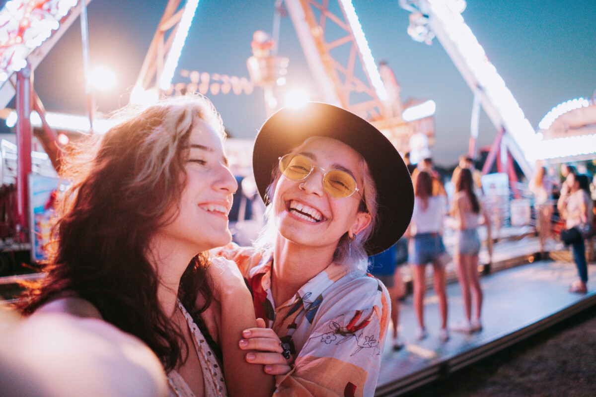 couple taking selfies at a fair