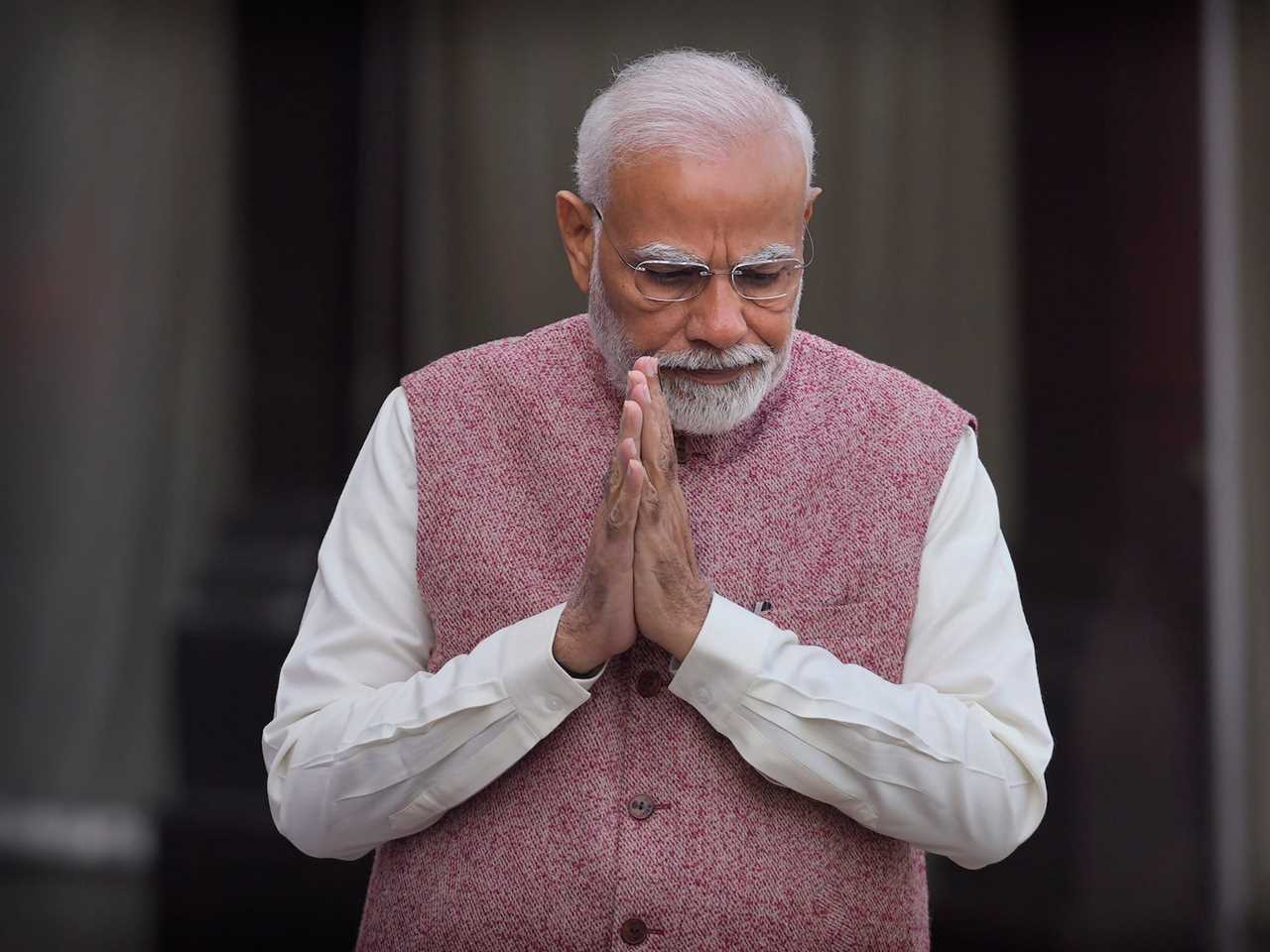 Indian Prime Minister Narendra Modi greets his cabinet colleagues as he arrives on the opening day of the winter session of the Parliament, in New Delhi, India, on December 7, 2022.