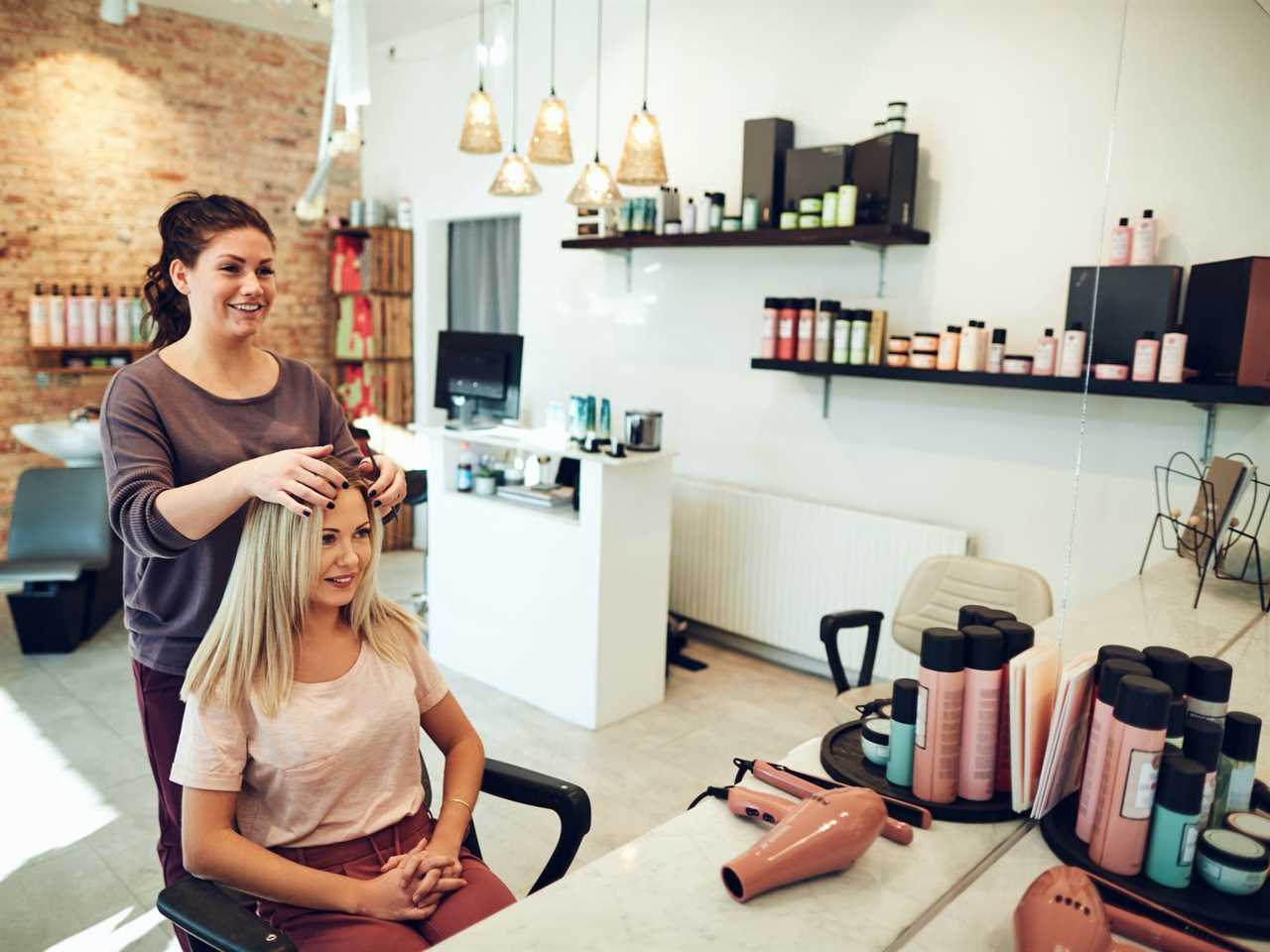 A woman sitting in a hair salon for an appointment