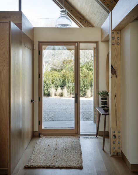 Just inside the entry is a door to the ultimate mudroom for handling post surf sessions, with heated concrete floors and a built-in drain, to hose off sandy feet and boards, and store them. The rug is from Serena &amp; Lily.