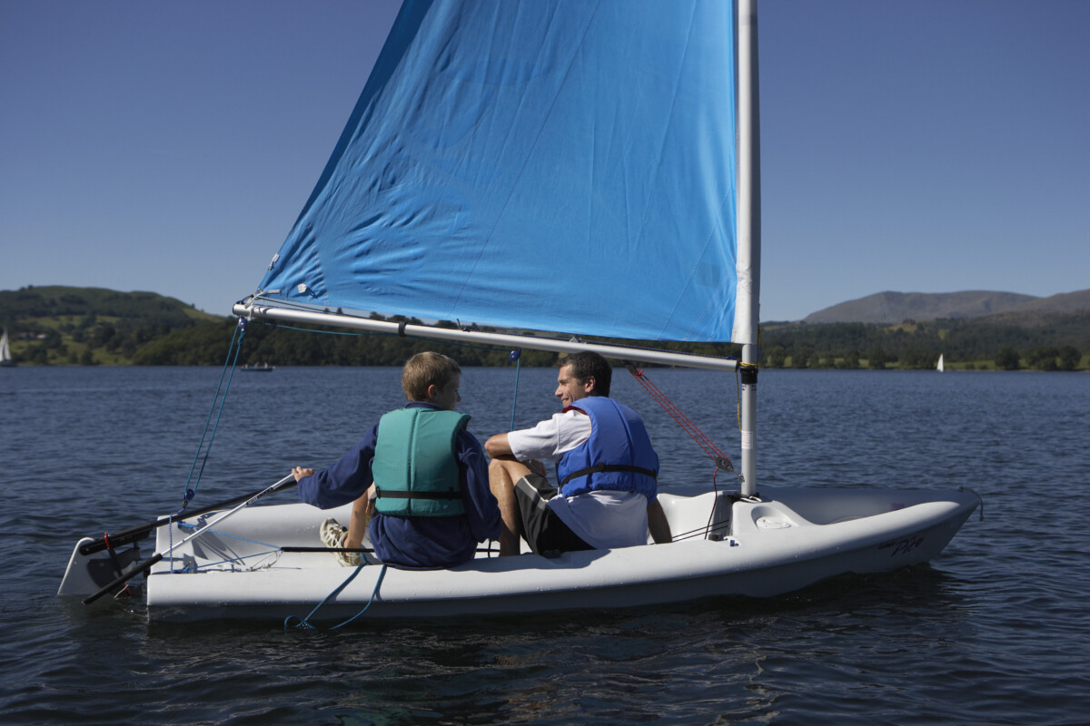 A family boating in a lake park with life vests on