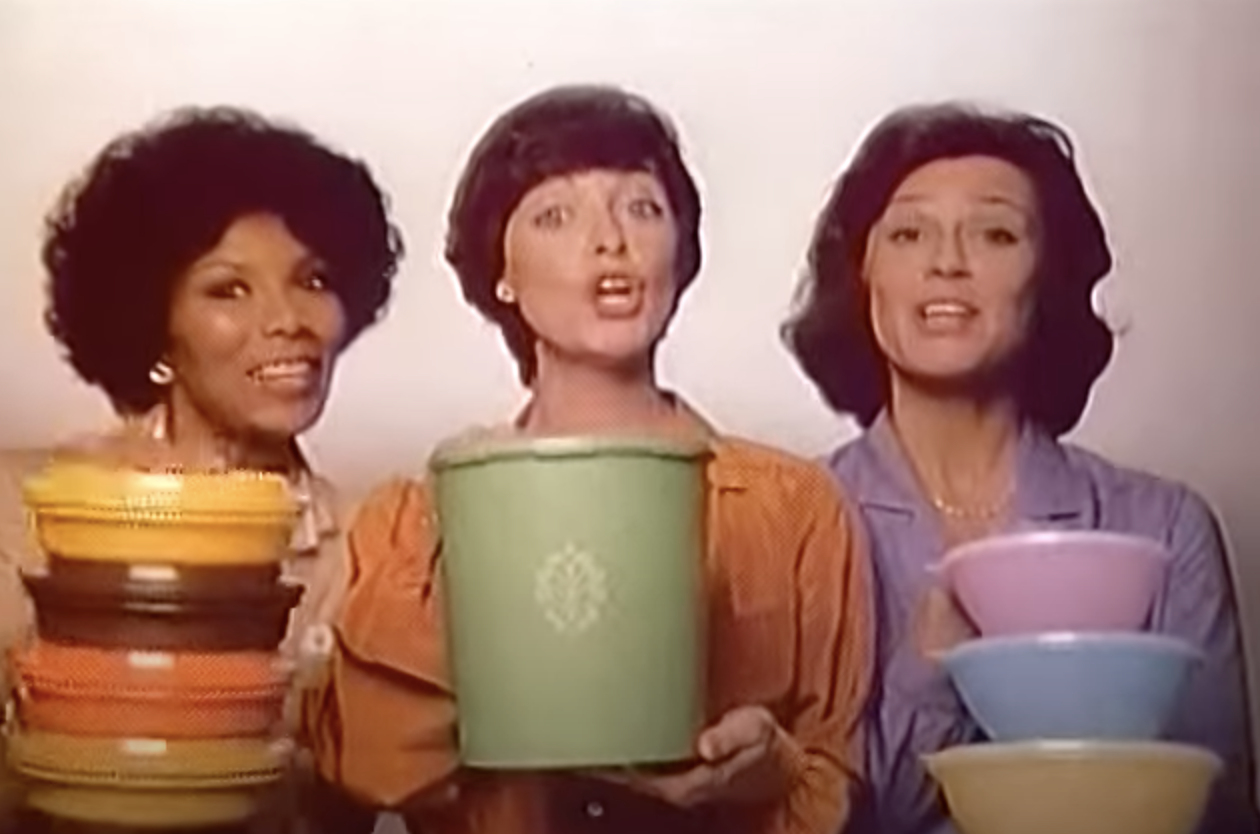 Three women holding Tupperware containers appear in a television ad for the brand in 1980.