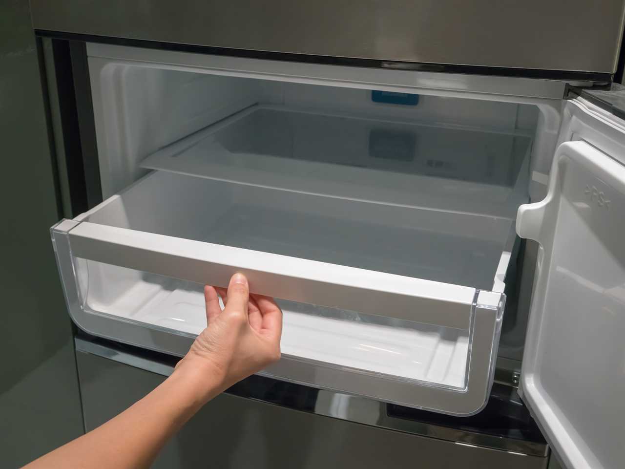 Someone pulls an under-cabinet ice maker out