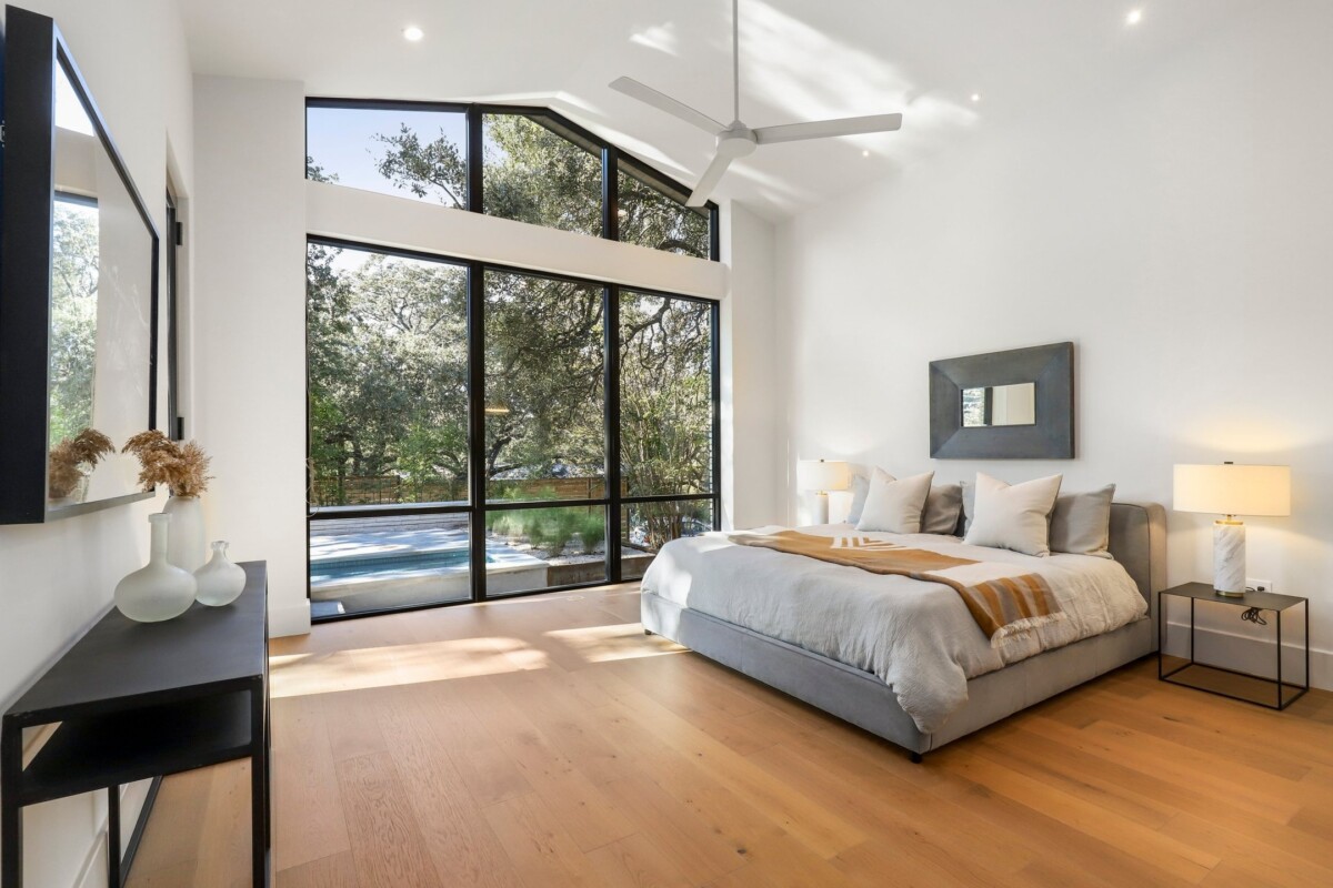 large windows airy primary bedroom