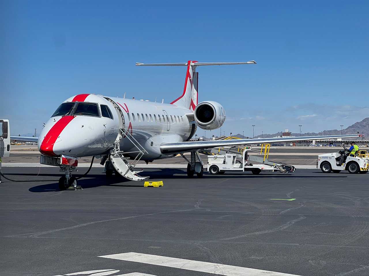 A JSX aircraft with its passenger loading door open after landing in Phoenix.