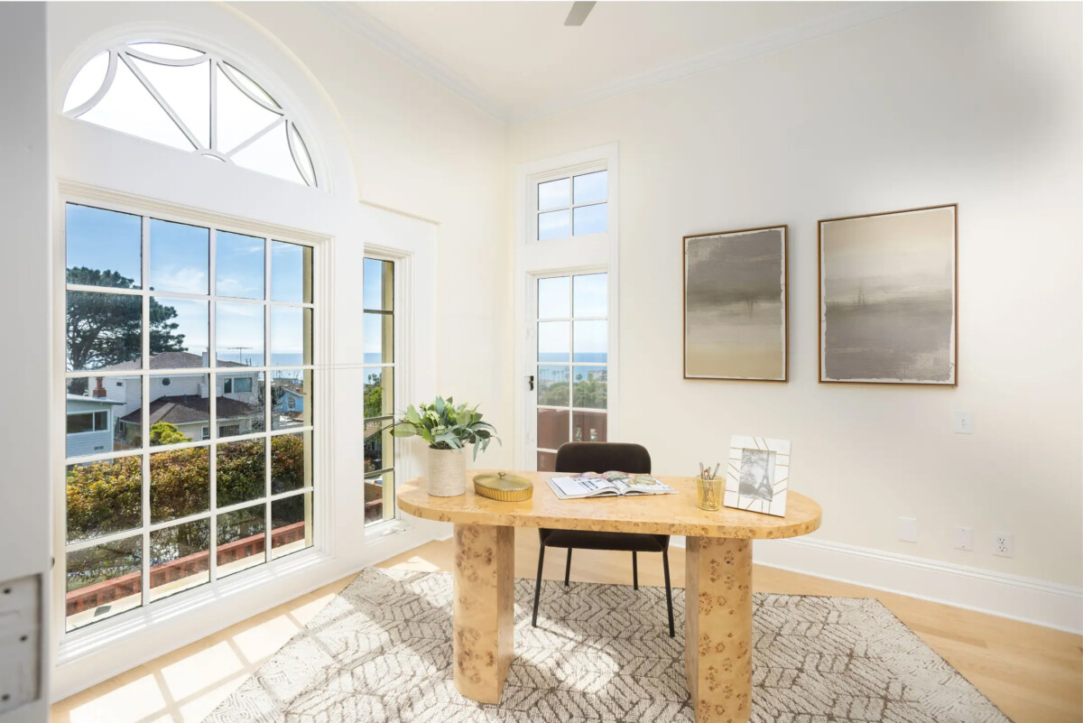 white bright office with large windows fresh white paint and a minimal desk