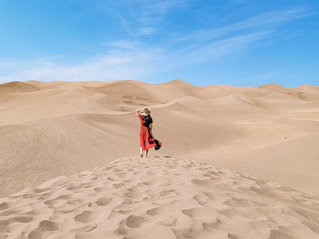 woman walking through a sand dune