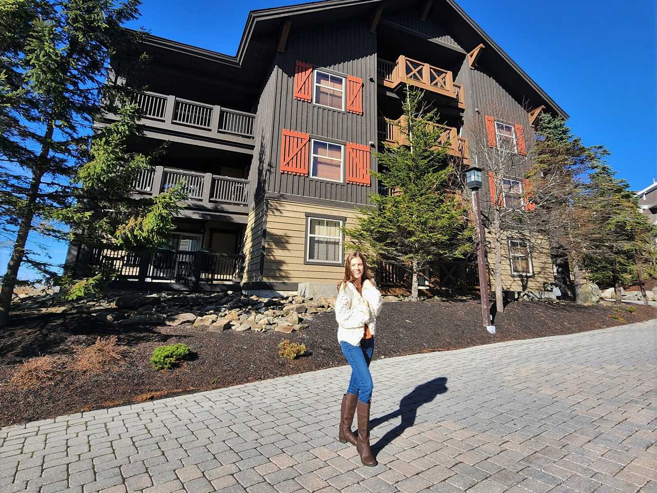 a woman stands in front of a condo