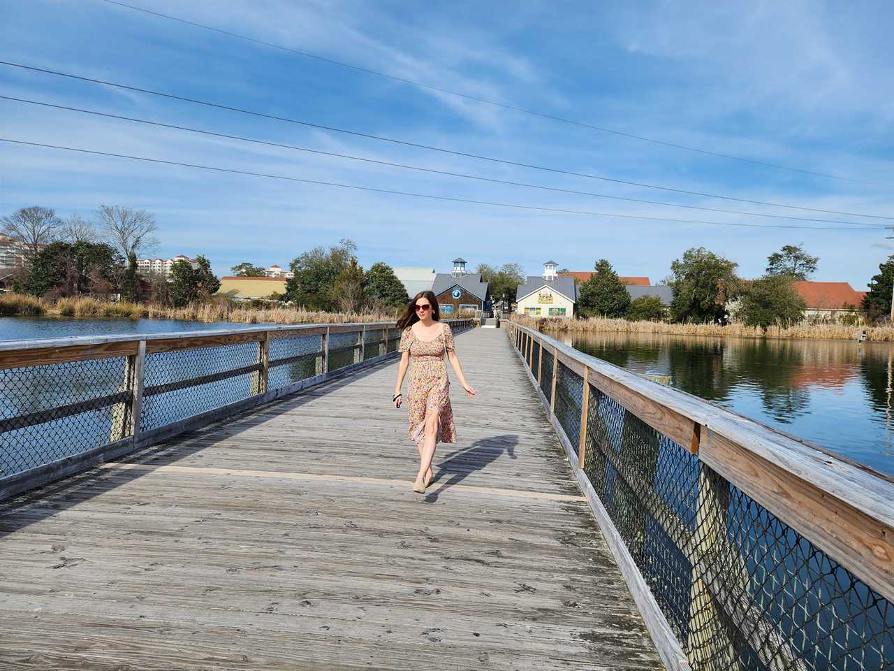 a woman walking on a boardwalk