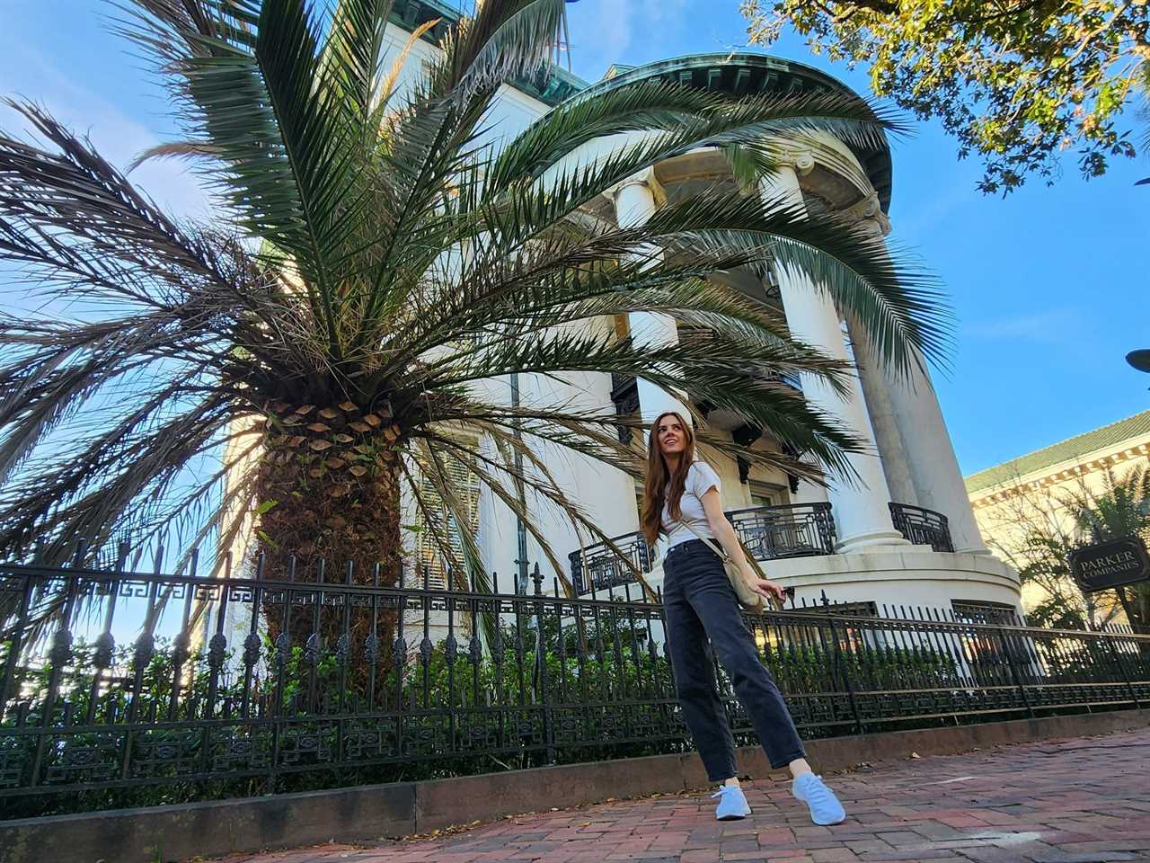 woman standing in front of a palm tree