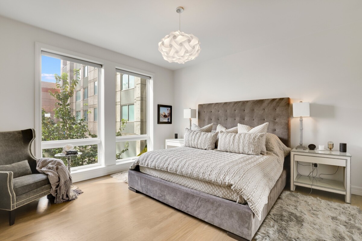 sleek primary bedroom unique lighting fixture modern gray bed