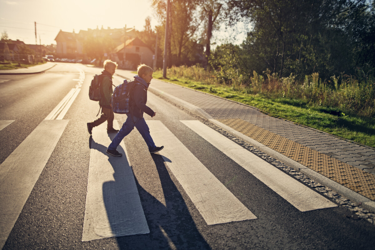 Students crossing the street on a sunny day