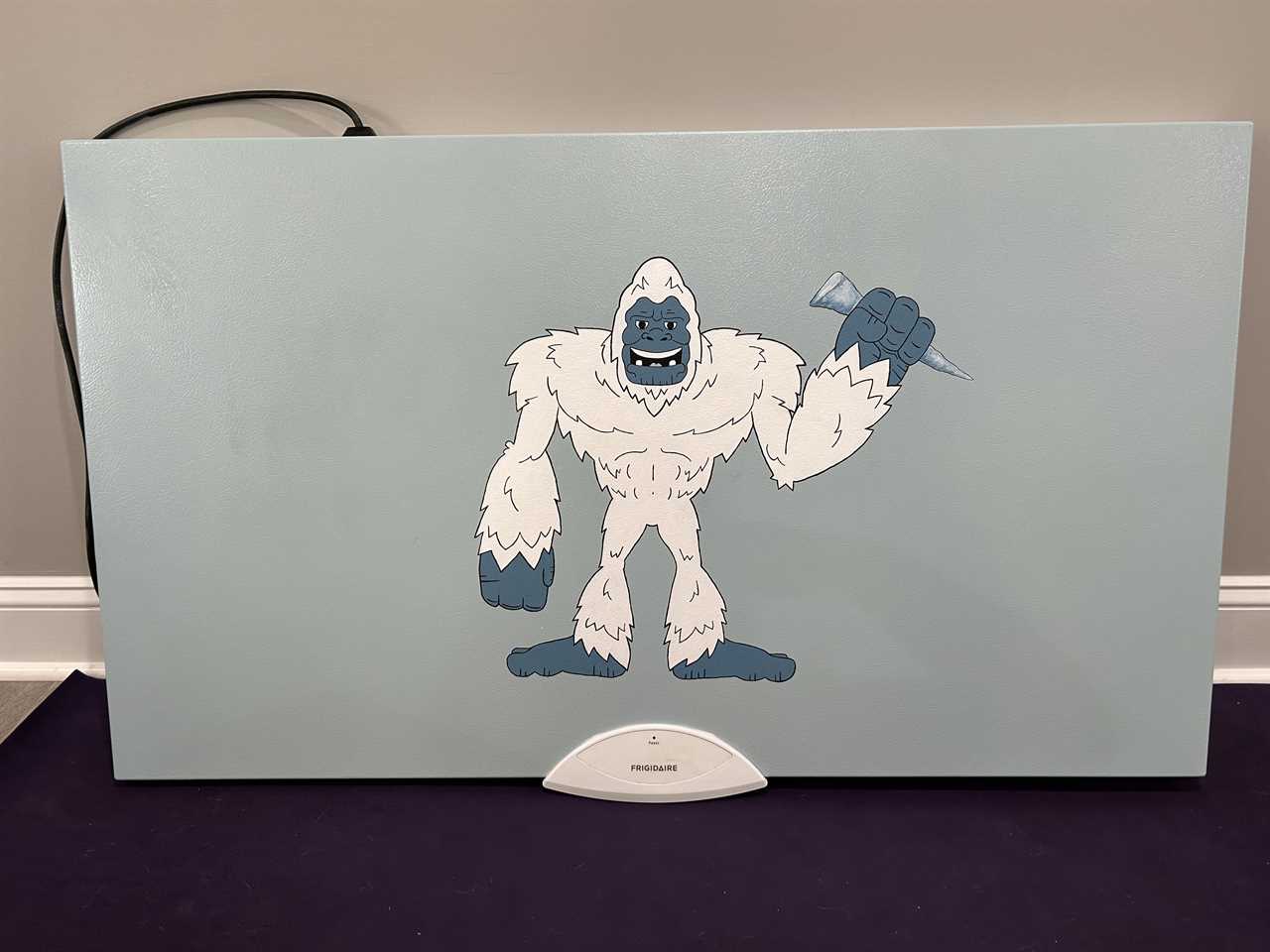 a yeti painted on a freezer